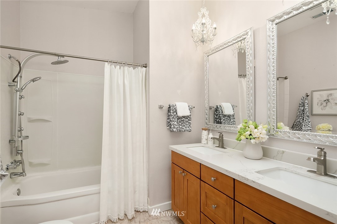 10902 Southeast 186th Street Renton, WA 98055 - Photo 24 of 32 a bathroom with a double vanity sink and a mirror