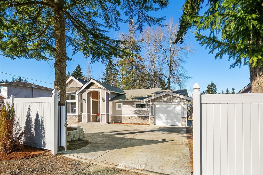 10902 Southeast 186th Street Renton, WA 98055 - Photo 3 of 32 a view of a white house with a large tree