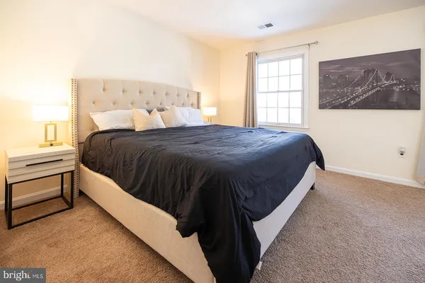 a bedroom with a bed and window