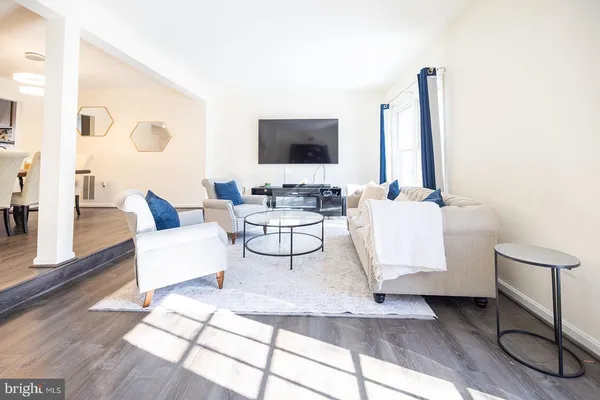a living room with chairs and a table