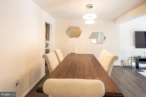 a dining room with furniture and wooden floor