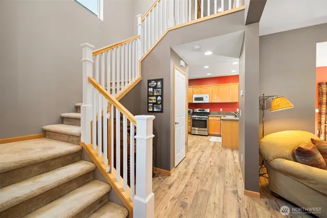 a view of a hallway with a couch and wooden floor