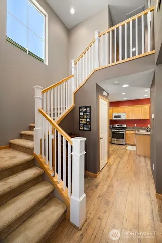 a view of entryway and hall with wooden floor