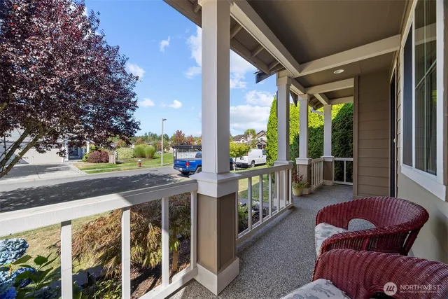 a balcony with chairs and a table