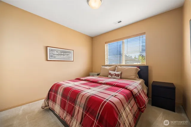 a bedroom with a bed and a lamp