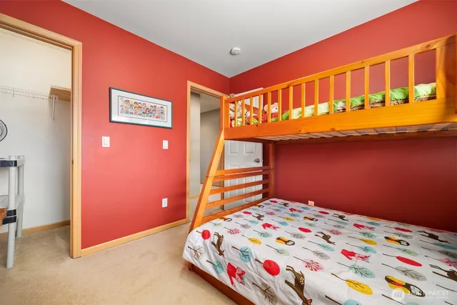 a bedroom with bed and paintings on the wall