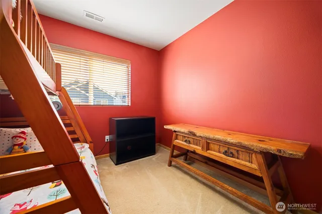 a view of a room with furniture and a window
