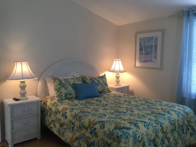 a bedroom with a bed and a lamp
