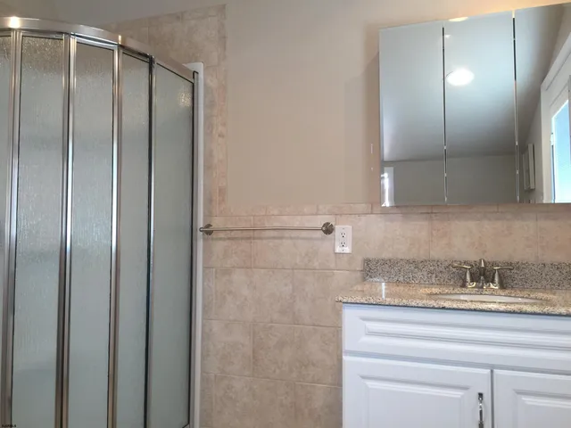 a bathroom with a shower and a sink