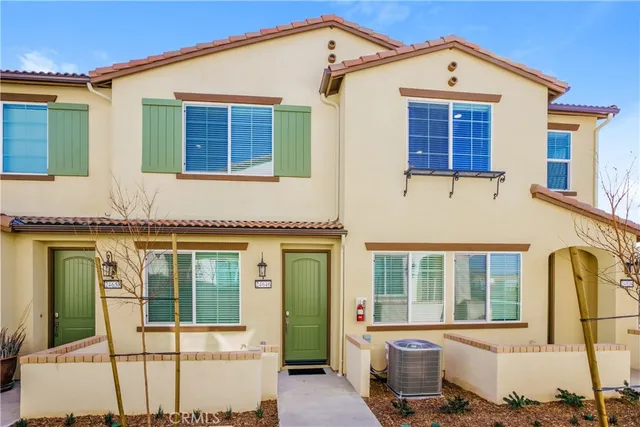 a front view of a house with large windows