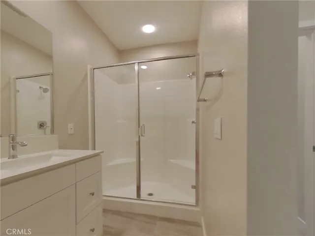 a bathroom with a shower sink and mirror