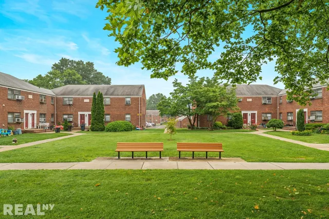 a front view of a building with a garden