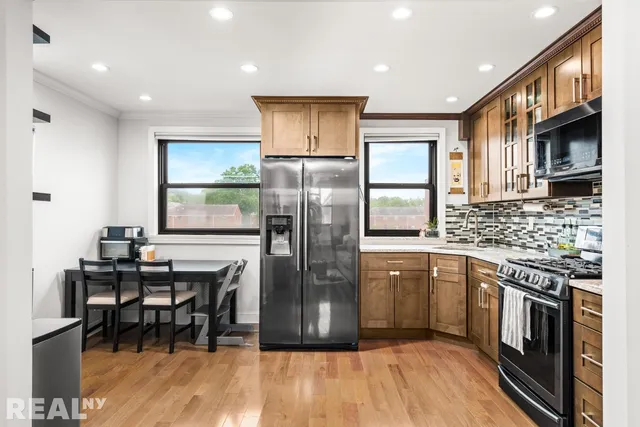 a kitchen with stainless steel appliances granite countertop a refrigerator and a stove top oven
