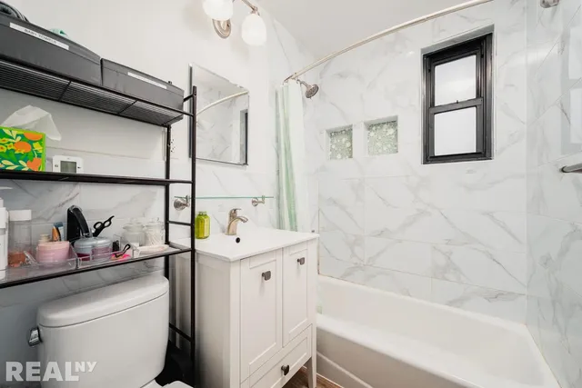 a bathroom with a sink a toilet and bathtub