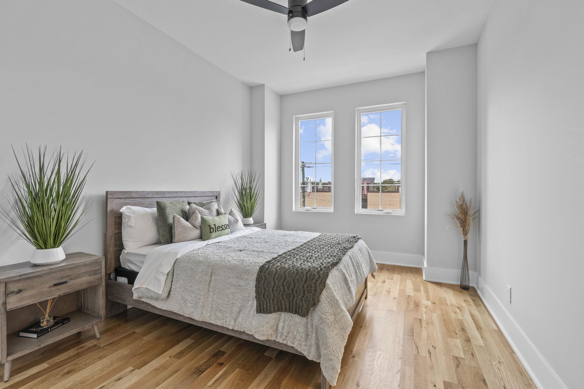 617 South West Street Raleigh, NC 27601 - Photo 12 of 44 a bedroom with a bed and a potted plant