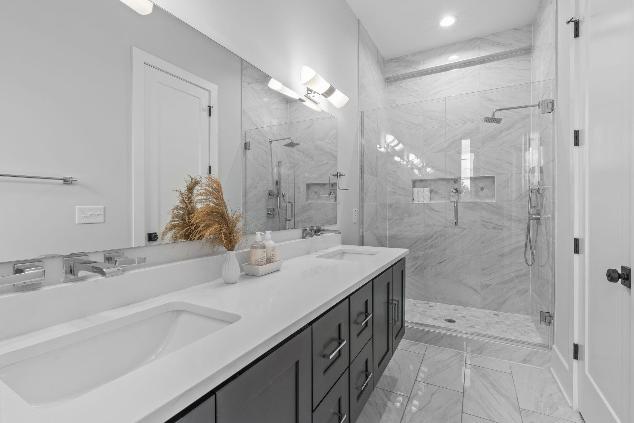 617 South West Street Raleigh, NC 27601 - Photo 14 of 44 a bathroom with a shower sink and mirror