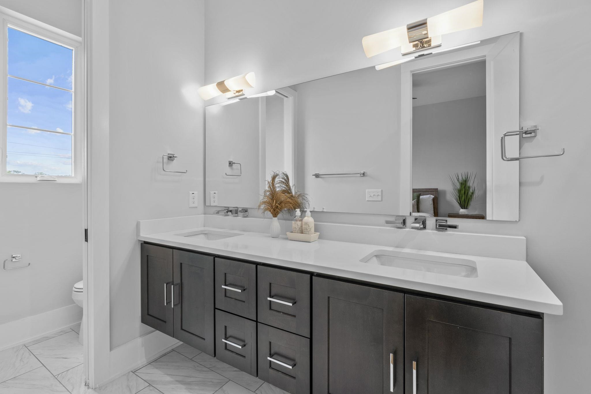 617 South West Street Raleigh, NC 27601 - Photo 15 of 44 a bathroom with a double vanity sink and a mirror