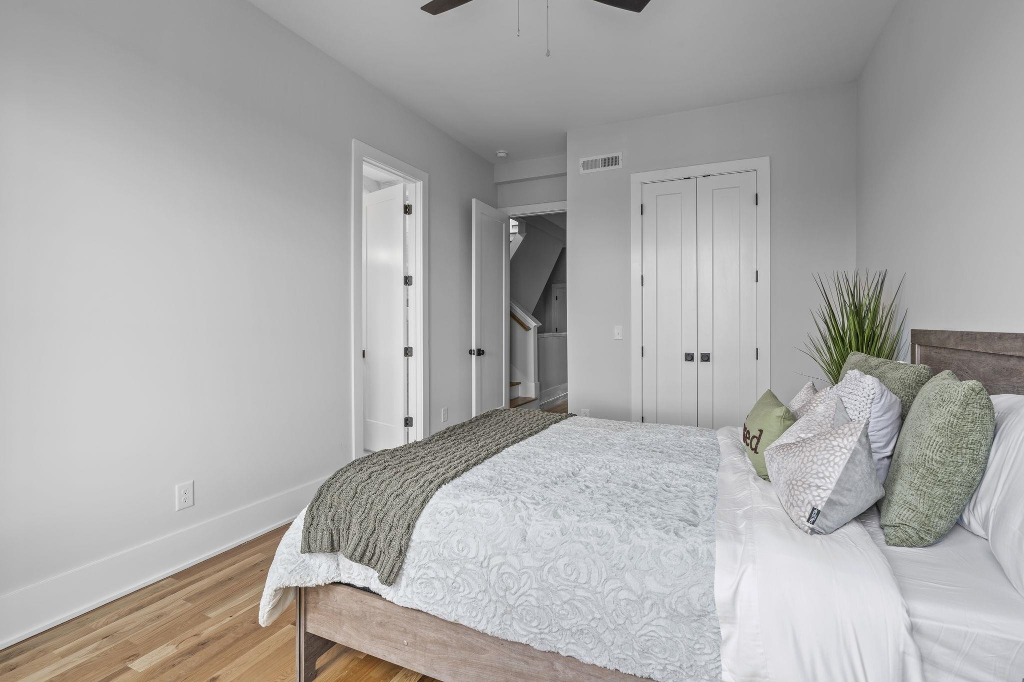 617 South West Street Raleigh, NC 27601 - Photo 17 of 44 a bedroom with a bed and a potted plant
