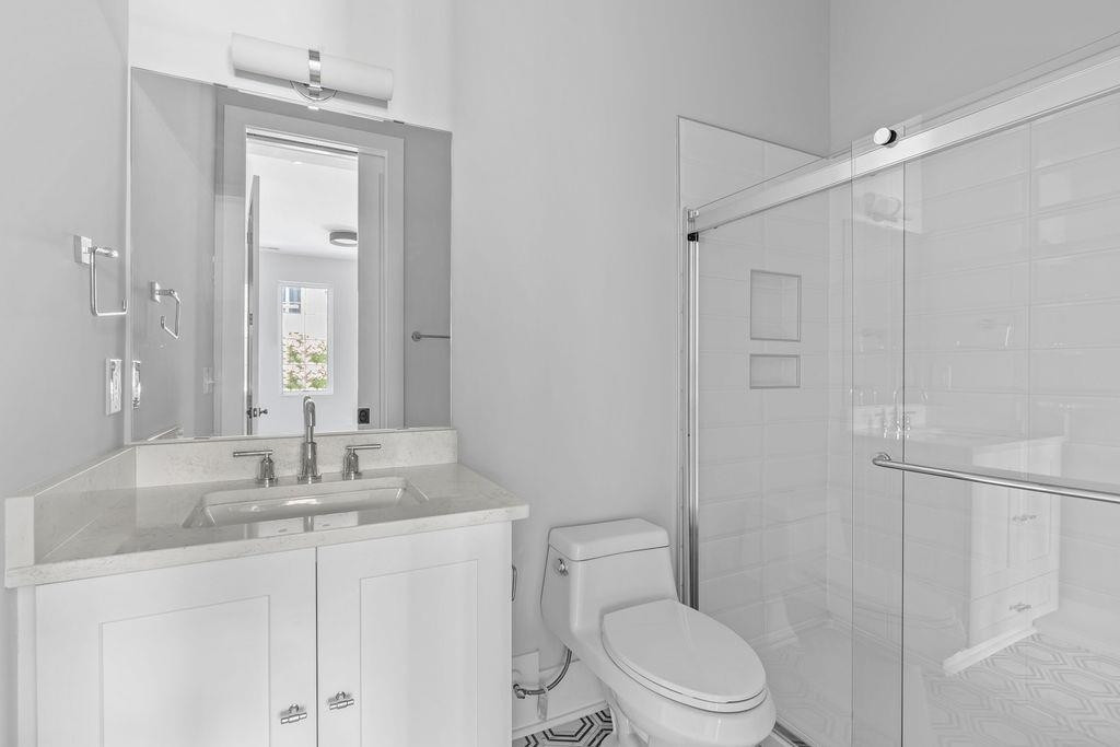 617 South West Street Raleigh, NC 27601 - Photo 26 of 44 a bathroom with a granite countertop sink toilet and shower