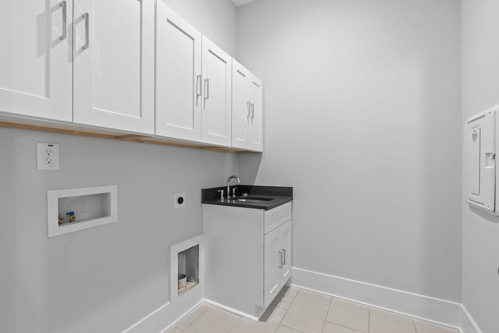 617 South West Street Raleigh, NC 27601 - Photo 27 of 44 a kitchen with granite countertop white cabinets and white appliances