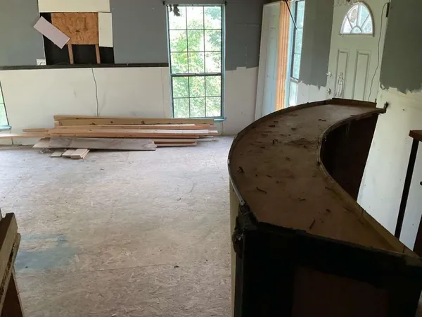 a living room with a bed furniture and a window