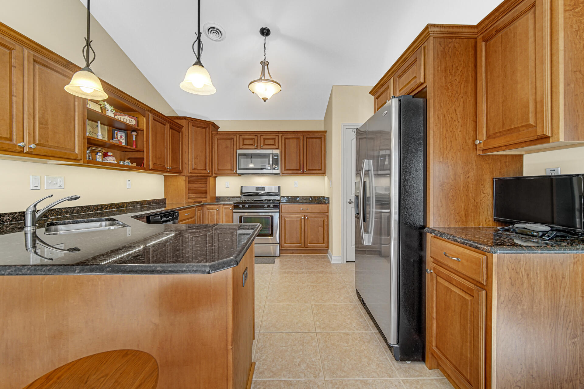 805 Veterans Lane Crown Point, IN 46307 - Photo 11 of 34 a kitchen with stainless steel appliances granite countertop a sink a stove and a refrigerator
