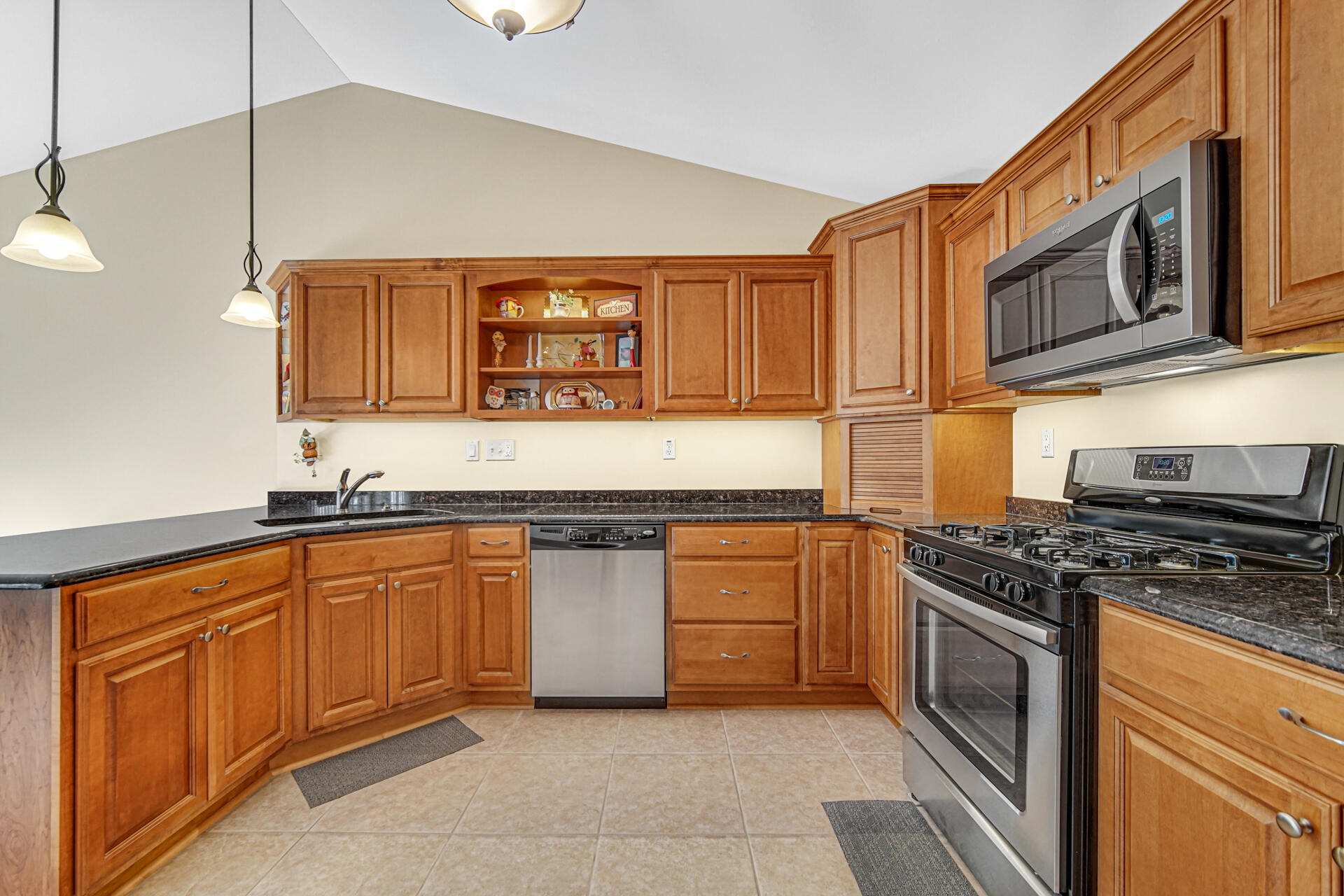 805 Veterans Lane Crown Point, IN 46307 - Photo 12 of 34 a kitchen with stainless steel appliances granite countertop a stove a sink and a microwave