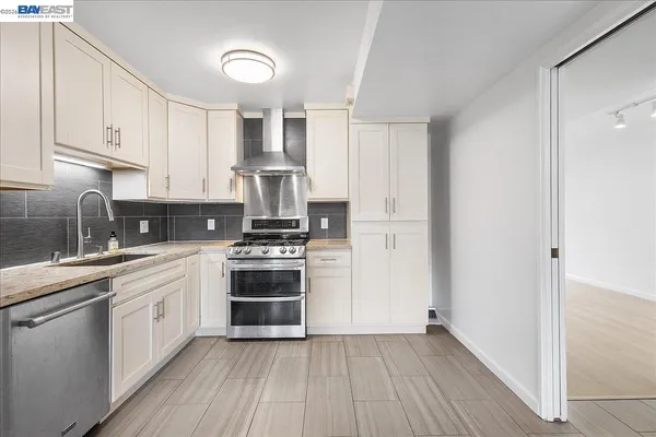 a kitchen with stainless steel appliances granite countertop a refrigerator and a table