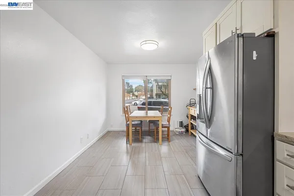 a view of empty room with wooden floor and fireplace