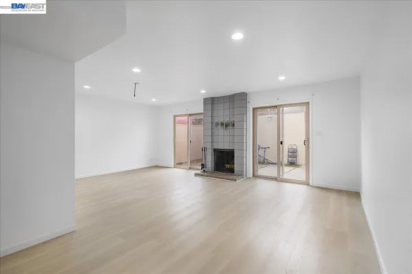 a view of an empty room with a fireplace