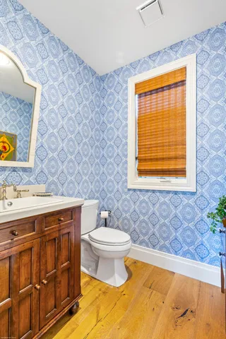 a view of a hallway with a dining table and a chandelier