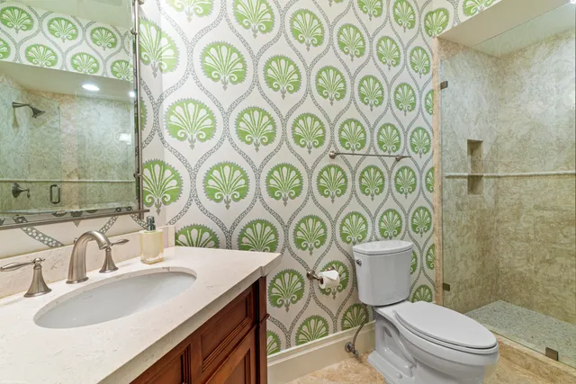 a spacious bedroom with a bed and a chandelier