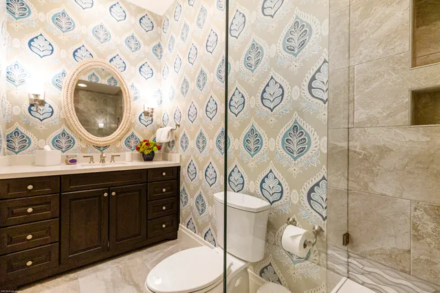 a bed sitting in a spacious bedroom next to a window