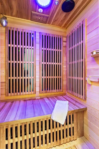 a view of a patio with table and chairs potted plants and a palm tree