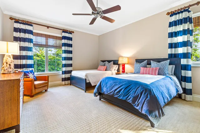 a front view of a house with garden and sitting area