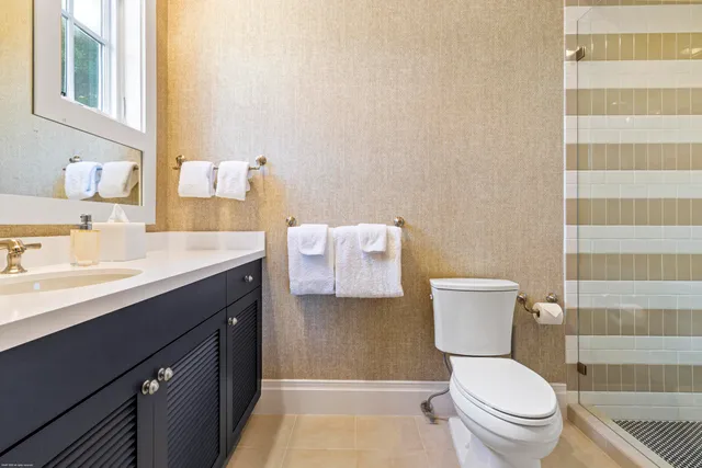 a view of a tennis ground with large trees