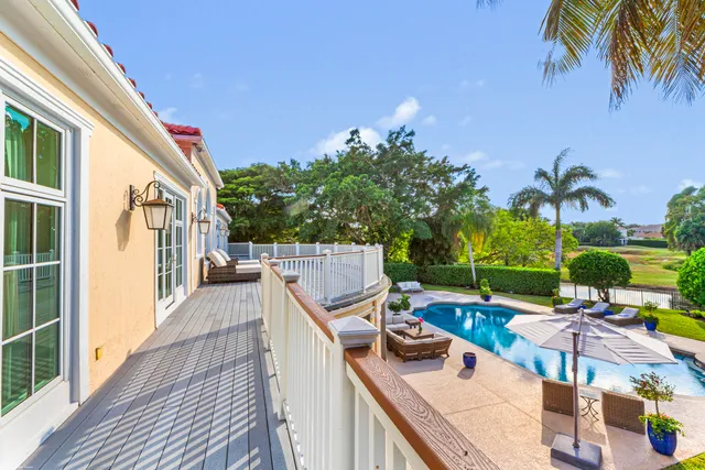 a view of a swimming pool with a patio and a yard