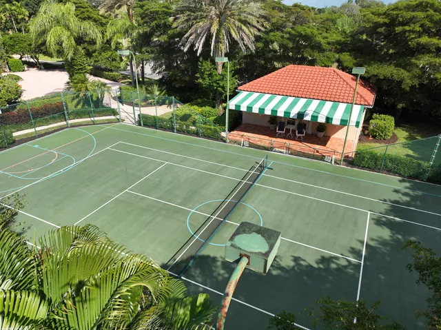 a kitchen with a dining table chairs and cabinets