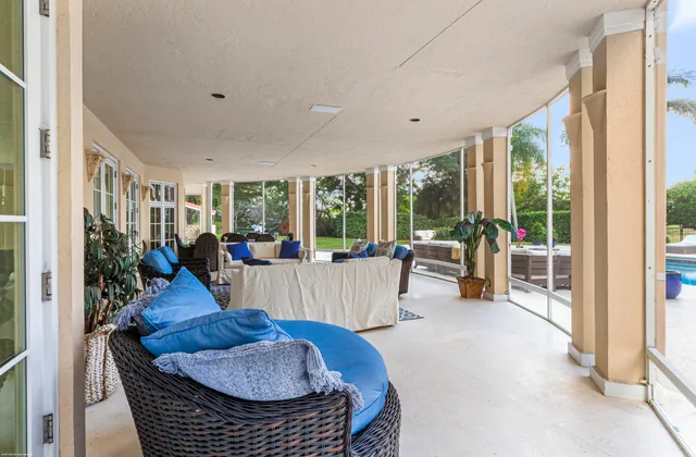 a view of a dining room with furniture a chandelier and wooden floor