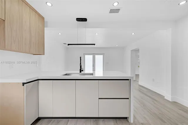 a close view of sink and cabinets