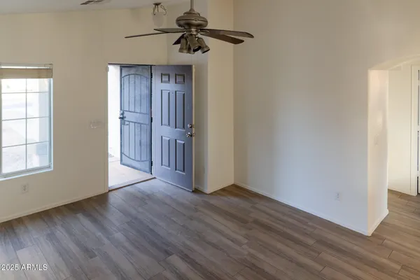 wooden floor in an empty room with a window
