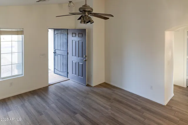 wooden floor in an empty room with a window