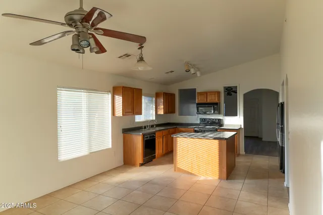 a kitchen with stainless steel appliances granite countertop a stove and a refrigerator