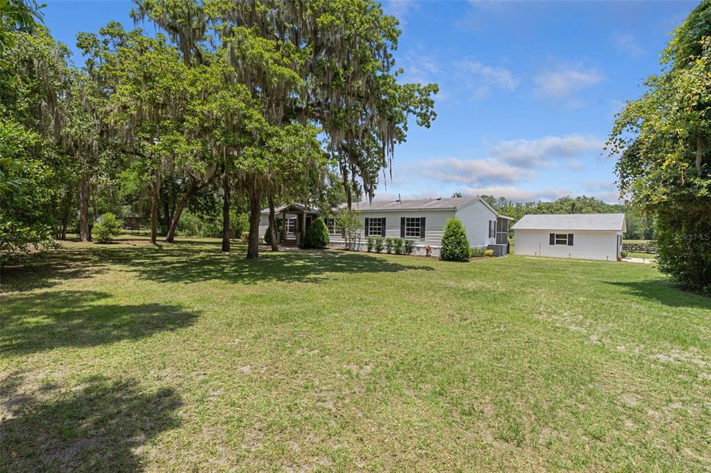 26255 Lambeth Road Brooksville, FL 34601 - Photo 6 of 76 a front view of a house with a yard
