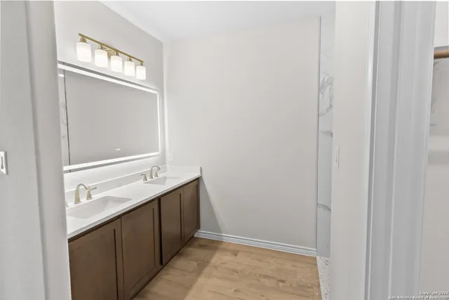 a bathroom with a sink a mirror and a vanity