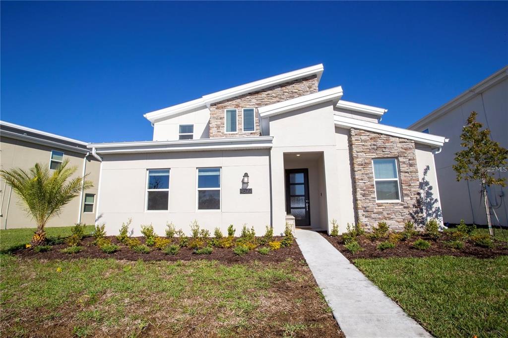 4577 Target Boulevard Kissimmee, FL 34746 - Photo 1 of 1 a front view of a house with garden