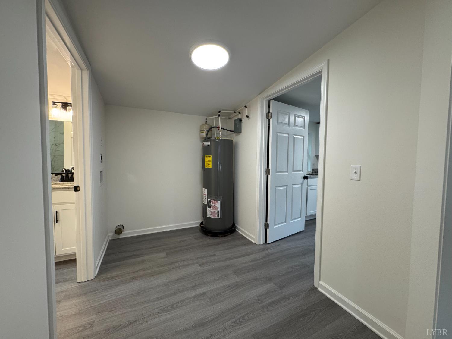 287 Harrell Street Appomattox, VA 24522 - Photo 12 of 17 an empty room with wooden floor and a bathroom