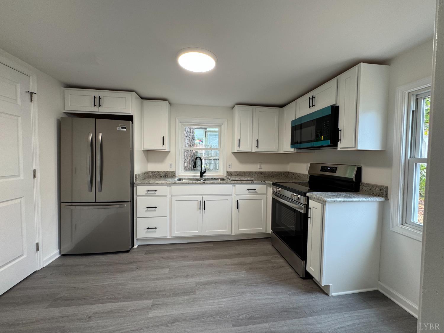 287 Harrell Street Appomattox, VA 24522 - Photo 9 of 17 a kitchen with a refrigerator stove and a sink