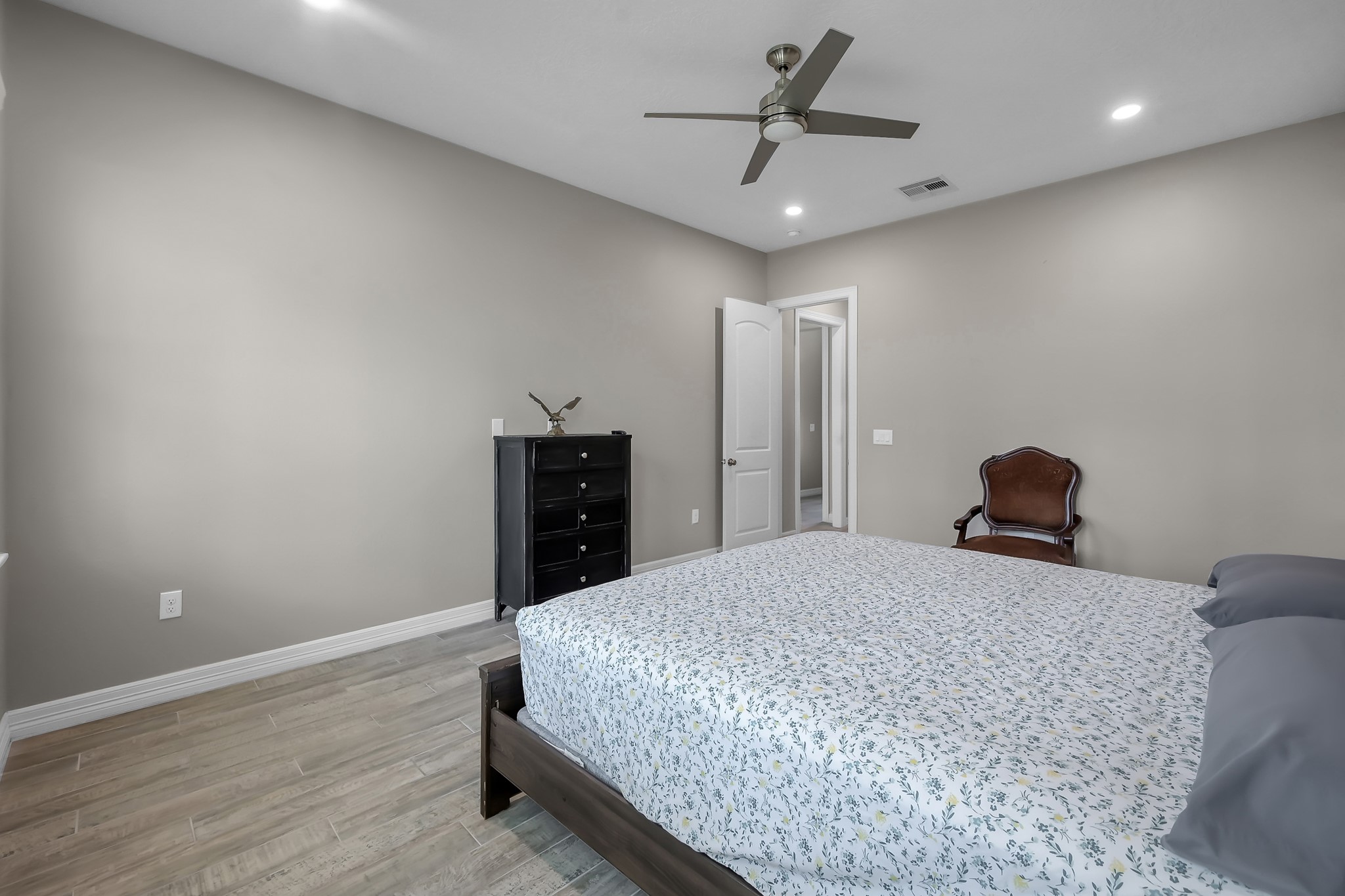 14609 Jim Stowe Road Conroe, TX 77302 - Photo 11 of 24 a bedroom with a bed and cabinets