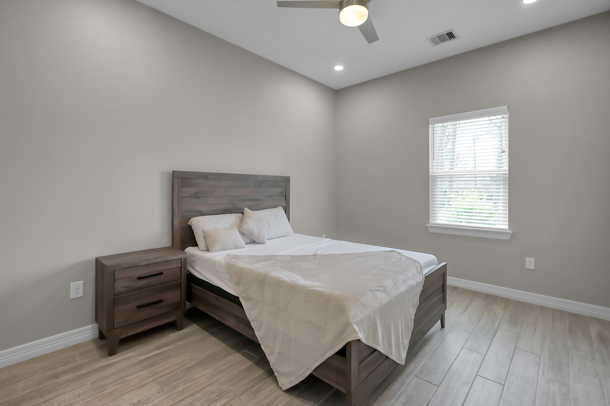 14609 Jim Stowe Road Conroe, TX 77302 - Photo 18 of 24 a large bed sitting in a spacious bedroom next to a window